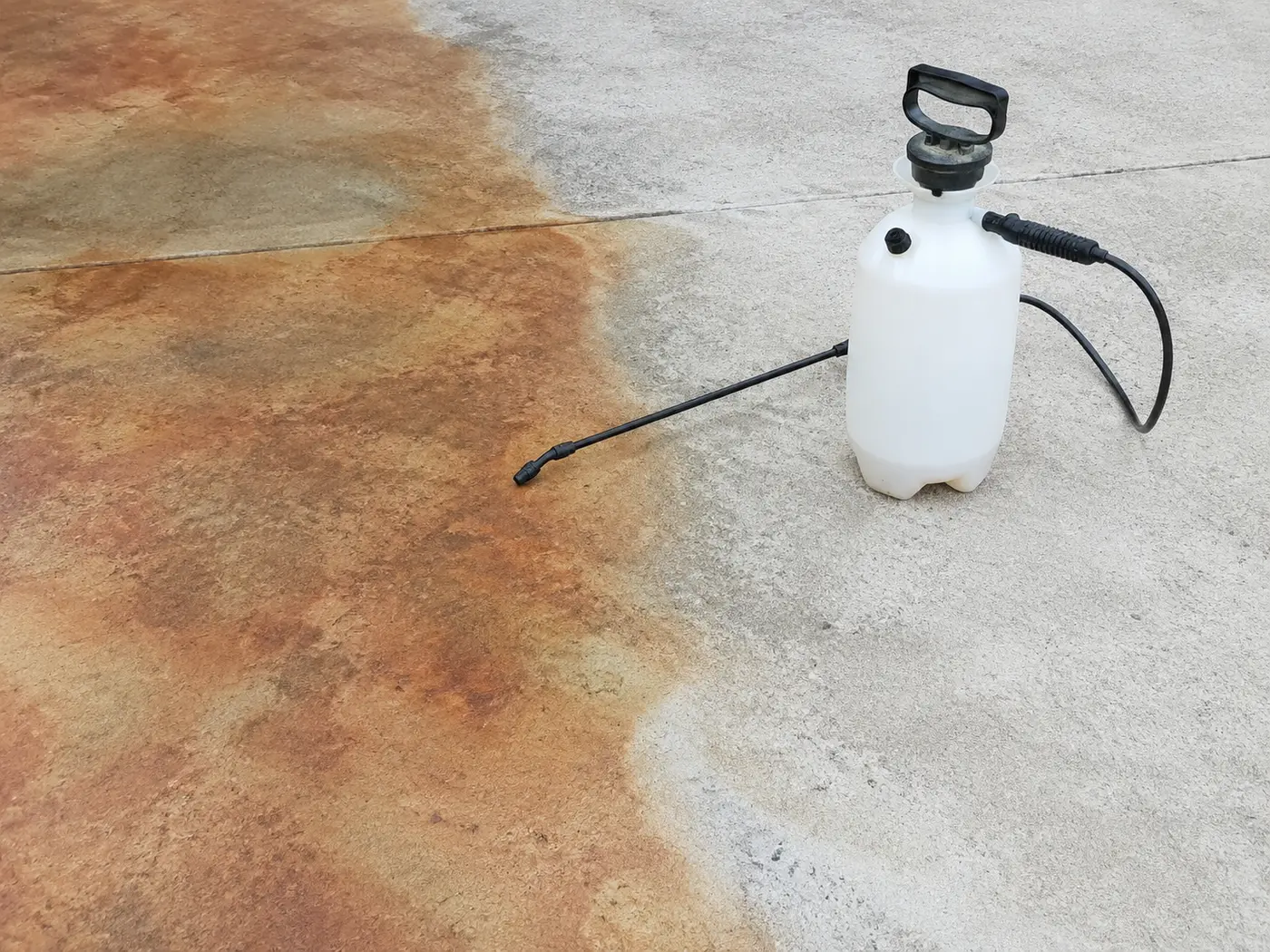 Acid stain blooming into mottled variegation across half a concrete slab